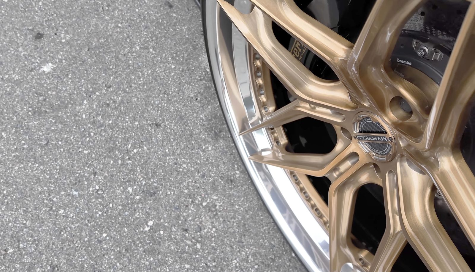Close-up of a gold forged wheel and Brembo brake caliper on a Liberty Walk Ferrari during Car Week