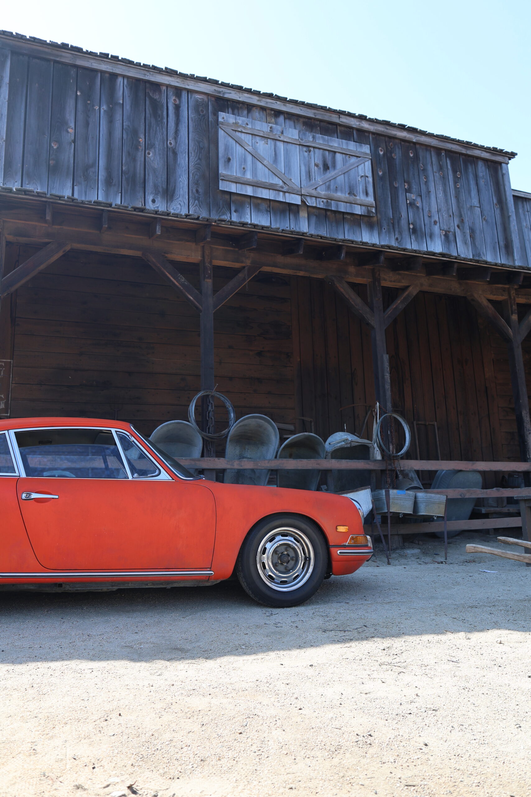 A red short-wheelbase Porsche 911 on the film backlot at Luftgekühlt 10