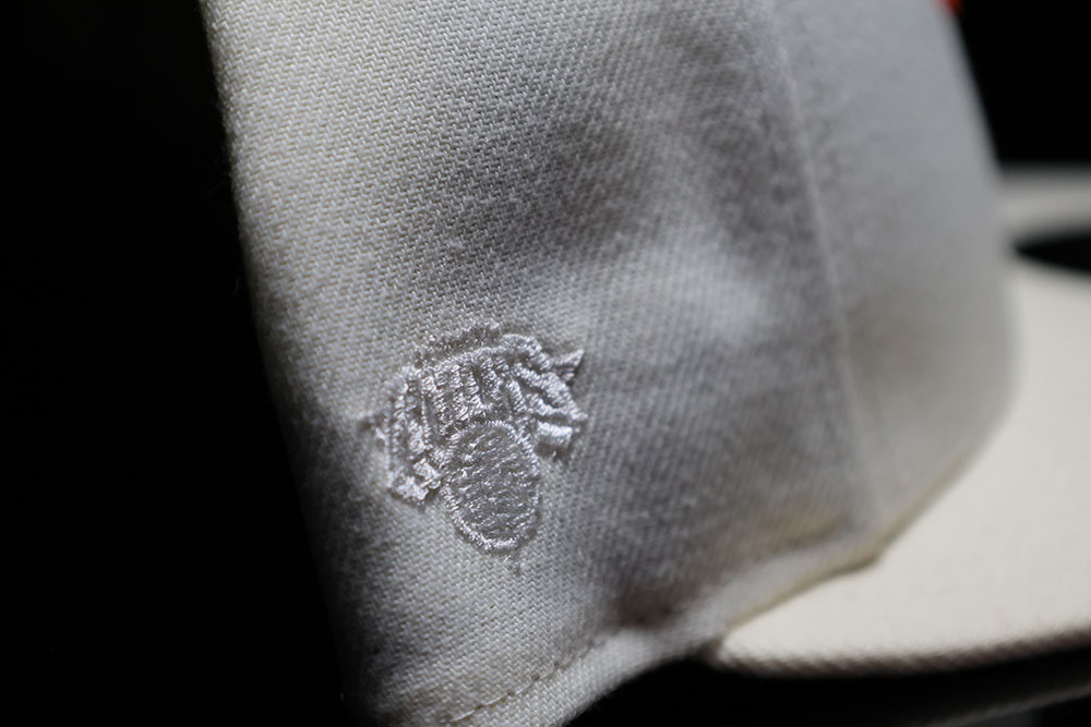 Tonal Knicks logo embroidered on the side of the Kith x New Era 59FIFTY fitted in Sandrift