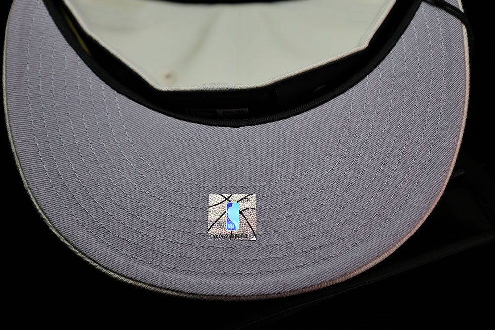 Grey underbrim and NBA hologram inside the Kith x New Era New York Knicks 59FIFTY fitted in Sandrift