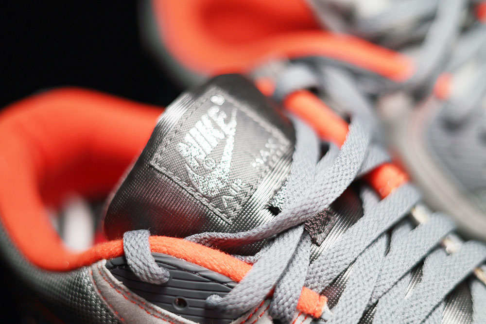 Front three-quarter view of the grey and orange Nike Air Max 90 NTSF San Francisco