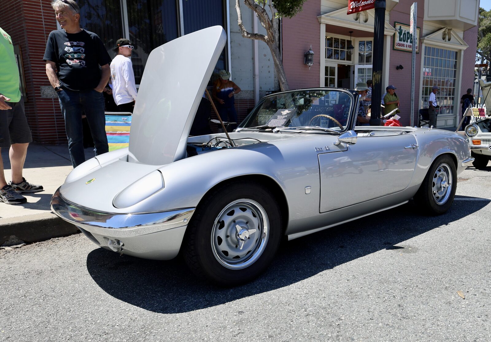 Silver classic convertible with open hood at a Monterey cars and coffee during Car Week