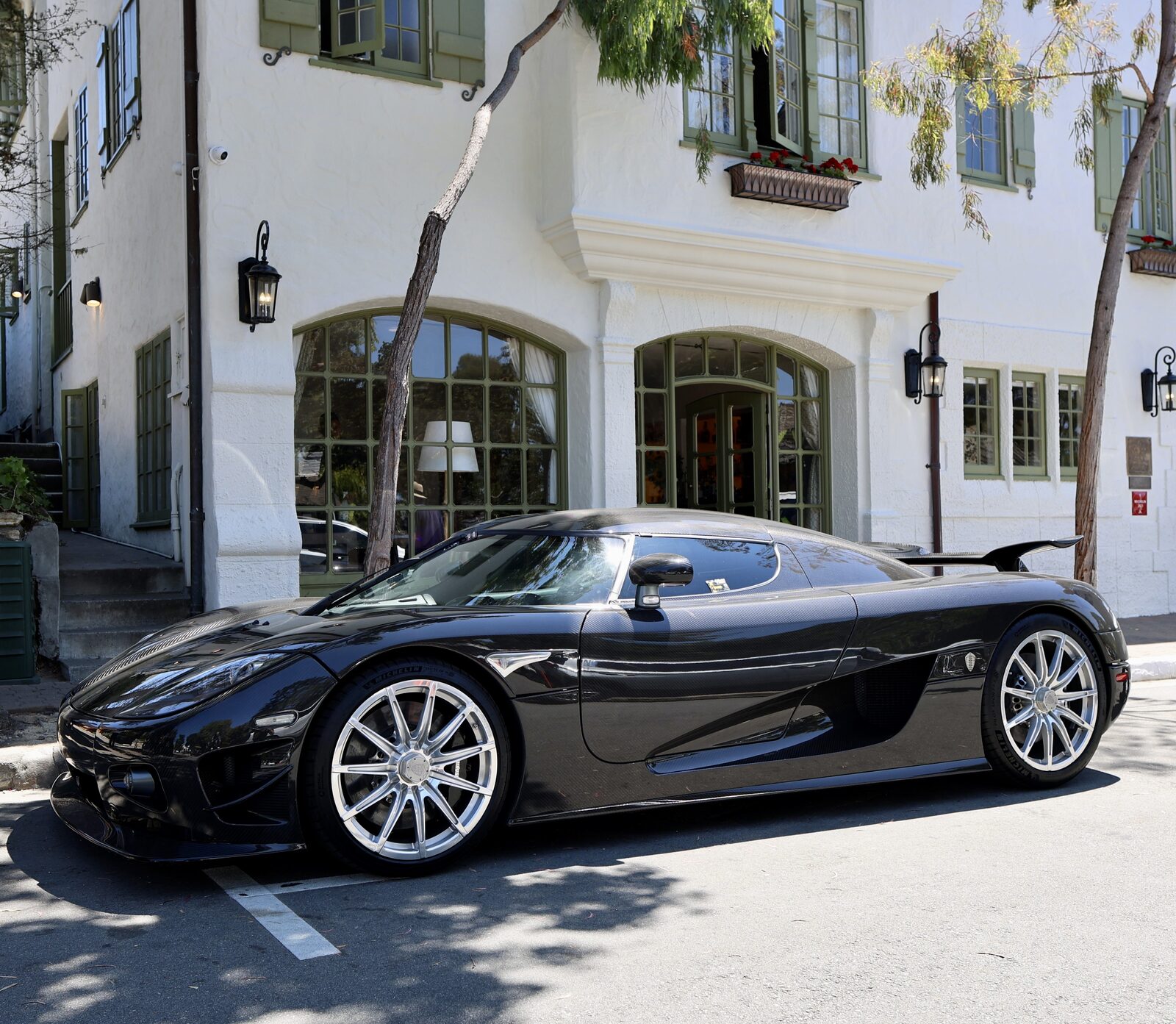 Black Koenigsegg parked on a Carmel street during Monterey Car Week