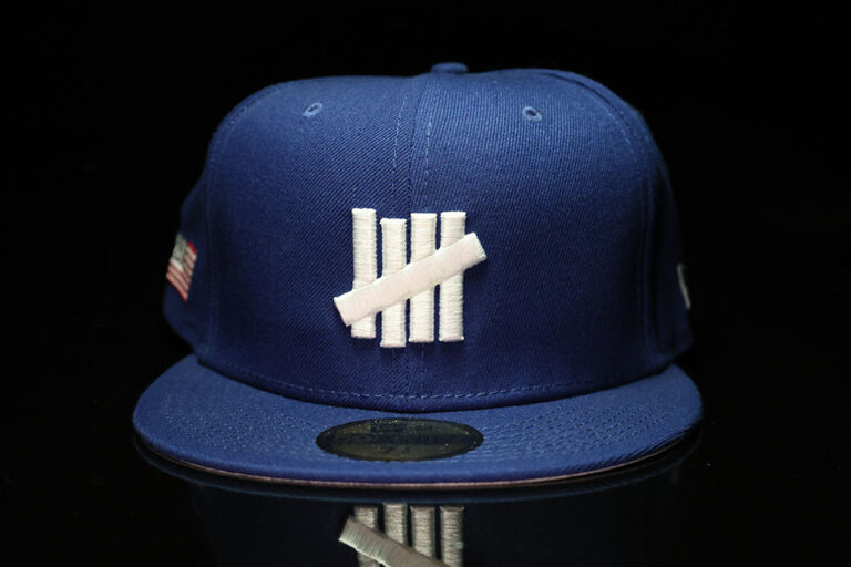 Front of the Undefeated x New Era Icon Fitted cap, blue USA colorway with the five-strike logo and USA flag